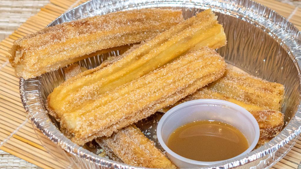 Classic Churros · Hot fresh Churros (6pcs) your choice of plain or cover with sugar and cinnamon. Come with 1 free dipping dark chocolate or caramel