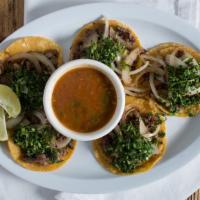 Street Tacos · Five steak tacos with cilantro, onion and a side of charro beans.