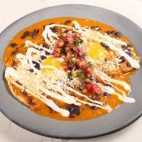 Rancheros · 2 eggs over tortillas, bacon, olla beans, cotija, crema, pico + salsa roja. You can add saus...