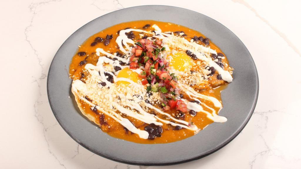 Rancheros · 2 eggs over tortillas, bacon, olla beans, cotija, crema, pico + salsa roja. You can add sausage, bacon, refried beans, guac or breakfast potatoes.