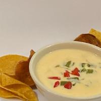 Queso Blanco  · Our signature white queso simmered onion and roasted poblanos