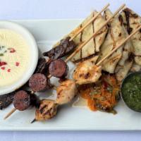 Texas Toothpicks New  · Grilled skewers of steak, chicken & smoked sausage with queso, chimichurri sauce, jalapeno r...