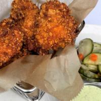 Red Hot Chicken Nuggets  · Crispy fried chicken tossed in our signature hot oil and spice rub. Served with poblano ranc...