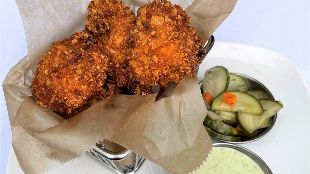 Red Hot Chicken Nuggets  · Crispy fried chicken tossed in our signature hot oil and spice rub. Served with poblano ranch and homemade pickles