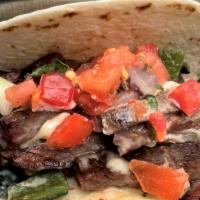 Steak Poblano Taco · Two Tacos - grilled skirt steak, roasted poblano, queso & pico. Served with coconut lime ric...