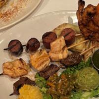 Churrascaritas  · Skewers of jumbo rojo shrimp, smoked pepper sausage, red chile steak, ginger- chipotle chick...