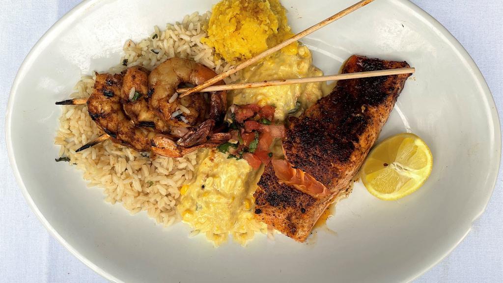 Seafood Mixed Grill · Grilled rojo shrimp, red chile salmon topped with fresh fruit salsa, blue crab shrimp enchilada with creamy corn sauce and pico de gallo, coconut lime rice and sweet corn cake