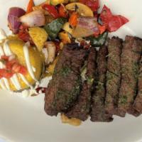 Carne Asada · Grilled skirt steak brushed with chimichurri sauce. Served on a bed of caramelized onion raj...