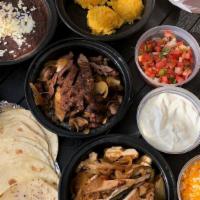 Fajita  Pack - Serves 4 To 6 · Grilled steak and chicken with onions, poblano & red peppers, smoky black beans, coconut lim...
