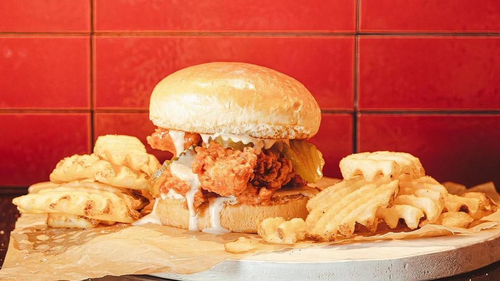 Nashville Hot Twisted Tender Sandwich · Nashville Hot crispy chicken tenders with pickles and ranch.