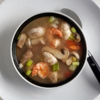 Tom Yum · Spicy soup with mushrooms, onions, lemongrass, kaffir lime leaves, chili paste topped with c...