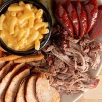 Three Meats · Pick three of our signature smoked meats along with two sides