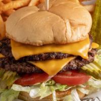 Classic Cheeseburger · Topped with cheddar, pickles, lettuce and tomato. Served with one side and a pickle.