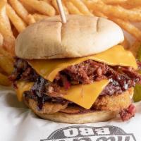 Roughneck Cheeseburger · A single burger patty topped with brisket, fried pickles, cheddar cheese, and BBQ Sauce.  Se...