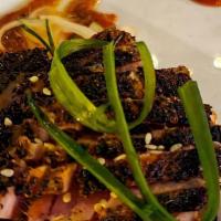 Tuna On Fire · Blackened tuna, cucumber salad, and sriracha.
