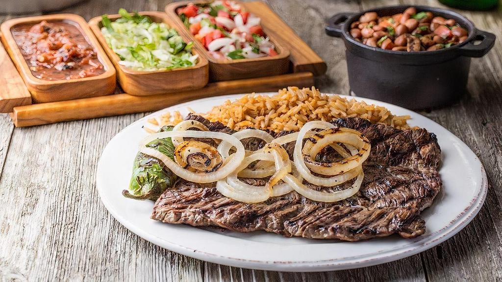 Carne Asada · Marinated skirt steak charbroiled to perfection served with rice, charro beans, pico de gallo, and tortillas.