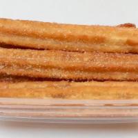 Churros · Cinnamon sticks filled with oozing caramel covered with cinnamon sugar.