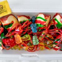 Manzana Loca · Crisp red apples covered in tamarindo candy cut up into slices with red and green chamoy, lu...