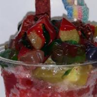 Picadilly · Dressed with red and green chamoy, lucas, and kool-aid then a cherry raspa and topped with p...