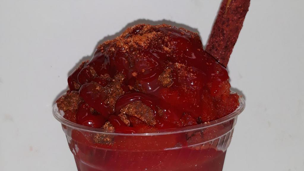 Chamoyada · Dressed with red chamoy and lucas then loaded with chamoy soft shaved Italian ice and topped with red chamoy, lucas, tamarindo candy and a candy straw.