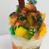 Mango Chango · Dressed with red and green chamoy and lucas. 3/4ths mango soft shaved Italian ice with a pic...