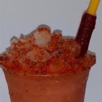 Dressed Topo Chico · 20oz cup of shaved ice, tajin, lime, salt, and Topo Chico with a candy straw.