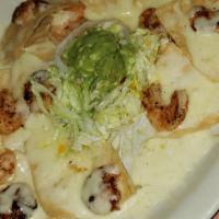 Shrimp Nachos  · Gluten-free. Grilled shrimp topped with Monterey jack cheese, and guacamole and jalapeños.