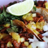 Tacos Al Pastor (3) · Gluten-free. Diced pork tenderloin in achiote sauce on corn tortillas taqueras with grilled ...