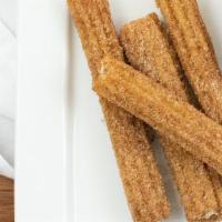 Churros · New. Traditional Mexican pastry dough with cajeta or Hershey's chocolate syrup, tossed with ...