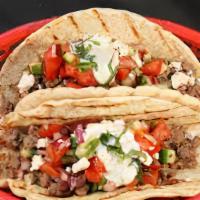 Great Greek Gyro Taco · Delicious gyro meat, lettuce, tomatoes, onions, feta cheese, and tzatziki sauce on our soft ...