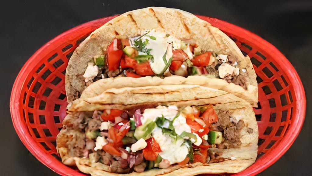 Great Greek Gyro Taco · Delicious gyro meat, lettuce, tomatoes, onions, feta cheese, and tzatziki sauce on our soft and flaky Indian tortilla (paratha).