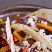 Beef Fajita Taco · Marinated & beef, grilled onions & peppers, pico de gallo & cheddar jack cheese.