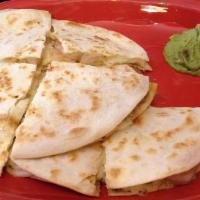 Shrimp Quesadillas · Flour tortillas filled with Monterey jack cheese and sautéed shrimp. Served with guacamole a...