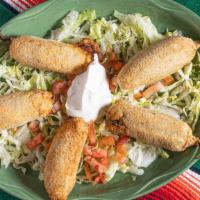 Stuffed Jalapenos · Spicy jalapeños stuffed with Monterey, cheddar or cream cheese. Served with sour cream.
