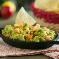 Guacamole (1/2 Pint) · Fresh avocados blended with chopped tomatoes and lime juice. Served on a bed of shredded let...