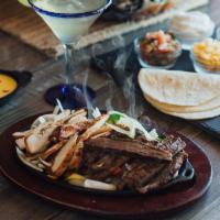 Mixed Fajitas · Charbroiled fajita beef and chicken served on a sizzling skillet with sautéed onions and bel...
