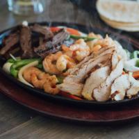 Fajita Ole · Fajita beef, chicken and shrimp served on a sizzling skillet with sautéed onions and bell pe...