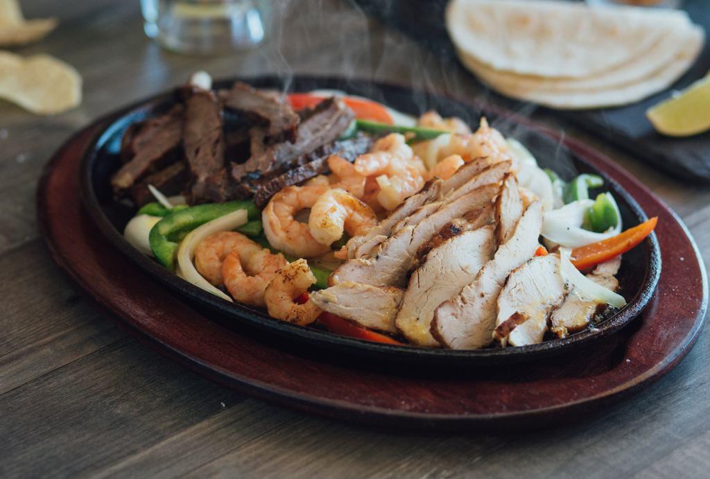 Fajita Ole · Fajita beef, chicken and shrimp served on a sizzling skillet with sautéed onions and bell peppers.