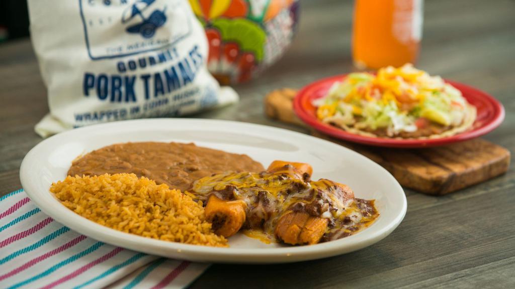 Tamales Ole · Pork tamales topped with chili con carne and shredded cheese, and a bean chalupa. Served with rice and beans.