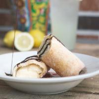 Chimichanga Cheesecake · A flour tortilla filled with cheesecake, deep-fried, rolled in cinnamon sugar and drizzled w...