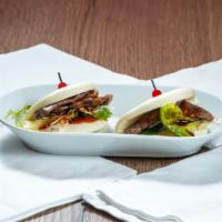 Gyu Bun · Steamed bun, grilled beef, special sauce, lettuce.