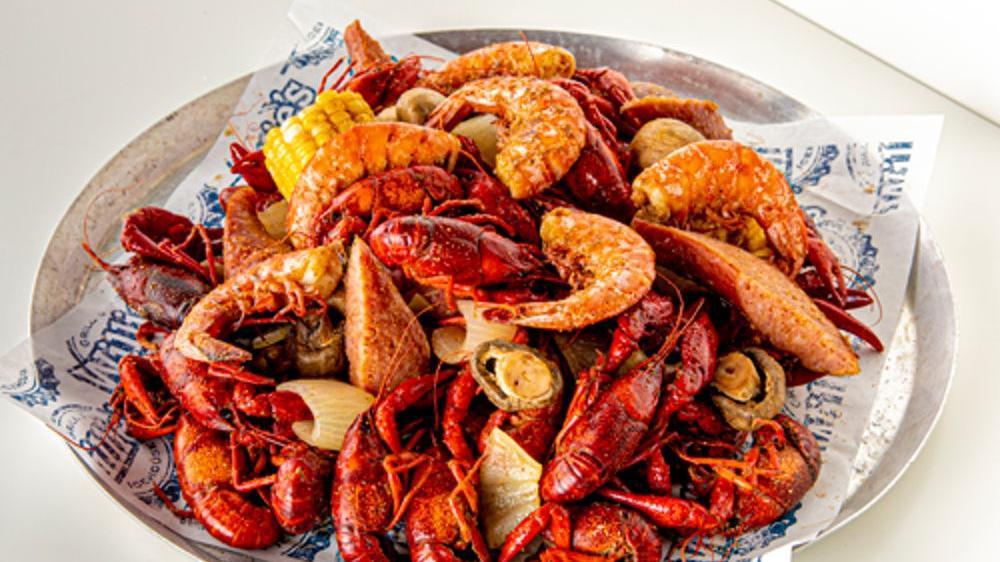 Ultimate Cajun Platter · 3 pounds boiled Louisiana crawfish, 1/2 dozen boiled shrimp, sausage, fresh corn & red potatoes, mushrooms and onions all packed up and ready to geaux in a reusable thermal bag!