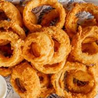 Hand Breaded Onion Rings · Hand breaded onion rings served with ranch.