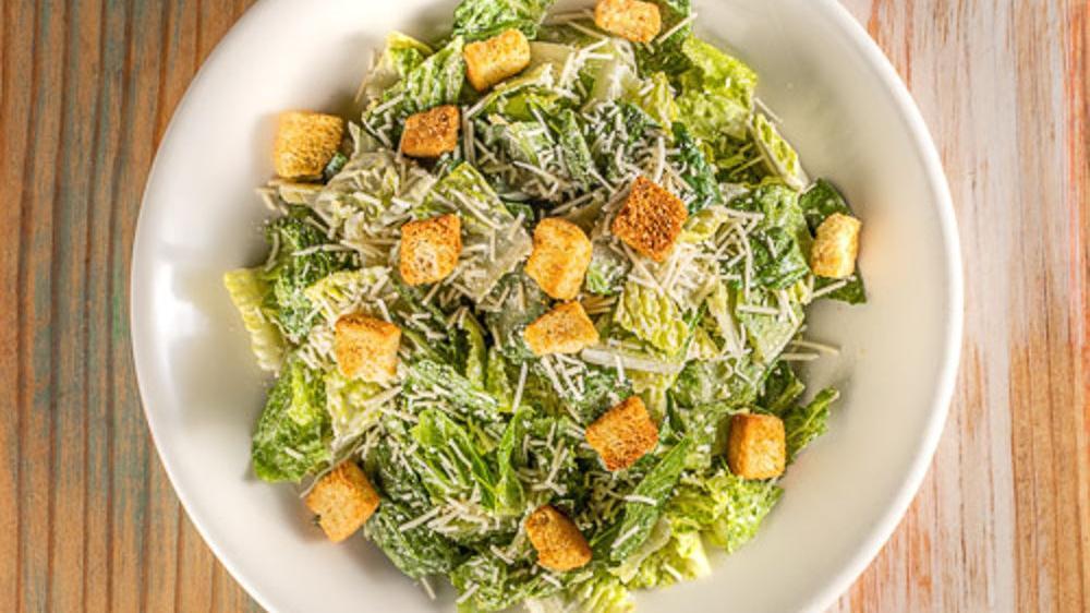 Caesar Salad · Romaine lettuce, parmesan cheese shredded, and croutons.