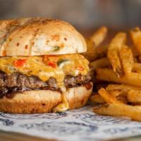 Cheddar Pepper Burger · Half pound burger with caramelized onions and roasted pepper cheese mix on a jalapeno chedda...