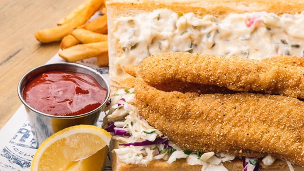 Cajun Catfish Poboy · $14.69. Grilled, fried, or blackened catfish served on hoagie roll with tartar and spicy slaw. Choice of one side.