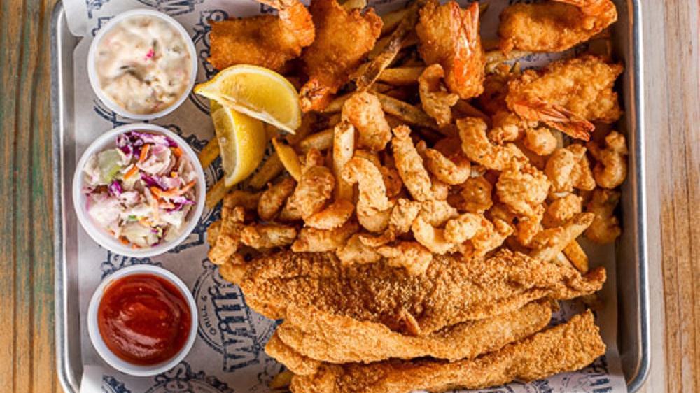 Seafood Platter · Fried catfish, fried shrimp, and fried crawfish tails served with cocktail, tartar, coleslaw, and lemon wedges. Choice of one side.