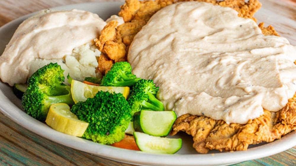 Country Fried Steak · Country fried steak smothered in cream gravy and served with choice of two sides.