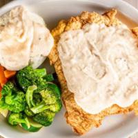 Country Fried Chicken · Country fried chicken smothered in cream gravy served with choice of two sides.