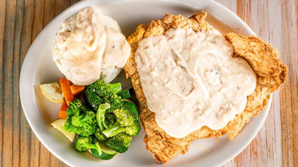 Country Fried Chicken · Country fried chicken smothered in cream gravy served with choice of two sides.